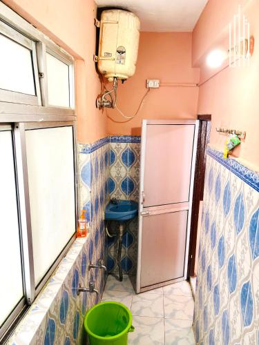 a bathroom with a sink and a toilet in it at PEMA Hotel VSTM in Darjeeling