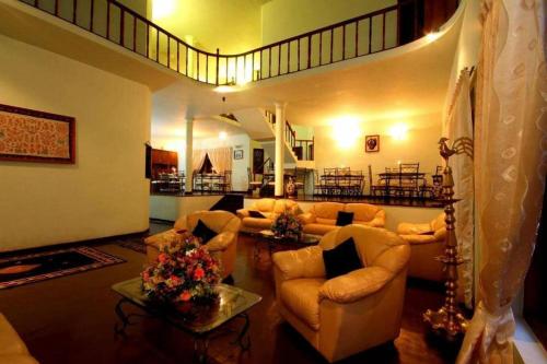 a large living room with couches and a staircase at The - Hideaway Ella in Ella