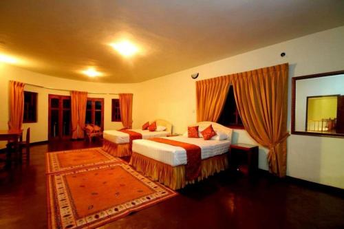 a hotel room with two beds and a rug at The - Hideaway Ella in Ella
