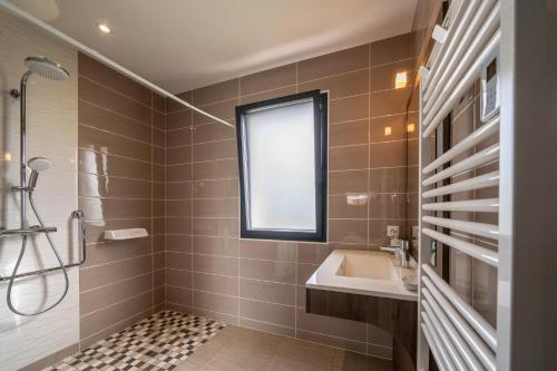 a bathroom with a sink and a window at Fleur Du Ciel Vendée in Challans
