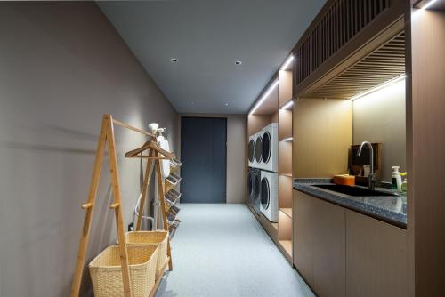 a laundry room with washer and dryer machines at Atour Hotel Hefei Changjiang Road Zhixincheng Annongda in Hefei