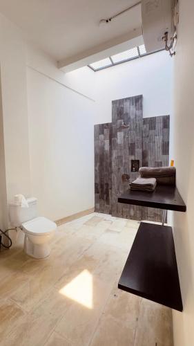 a white bathroom with a toilet and a sink at Tris Villa 3 in Bumbang