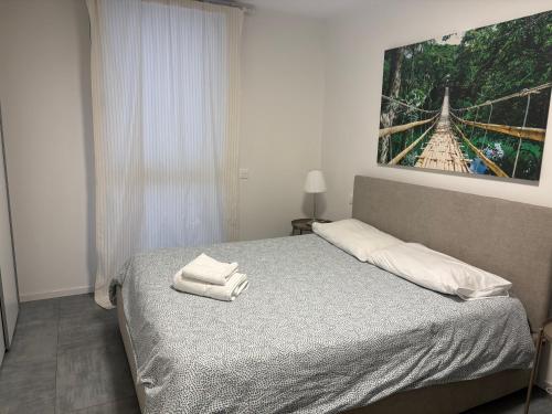 a bedroom with a bed with two towels on it at LabPark enjoy Melano in Melano
