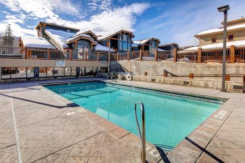 a swimming pool in front of a house at Hotel studio with views fireplace & close to everything in Park City