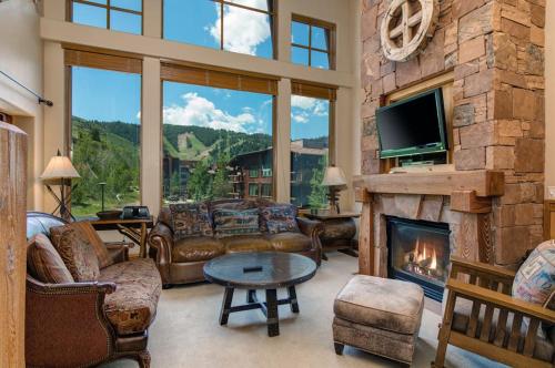 a living room with couches and a fireplace at Epic view condo with fireplaces & close to everything in Park City