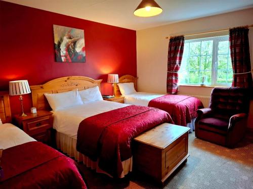 a hotel room with two beds and a chair at Lake Avenue House in Ballyconnell