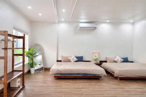 a room with two beds and a ladder in it at Sunset Garden in Phúc Trì