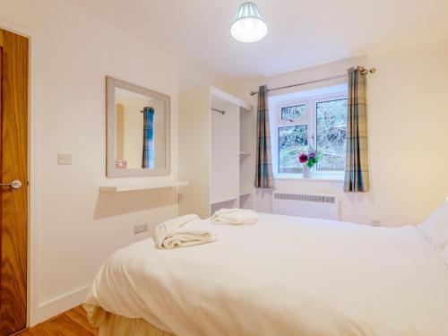 a bedroom with a large white bed and a window at 2 Bed in Bridgnorth oc-77721 in Highley