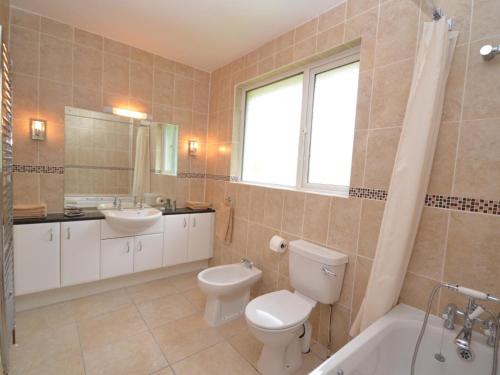 a bathroom with a toilet and a sink and a tub at 2 Bed in Bideford oc-sandb in Instow