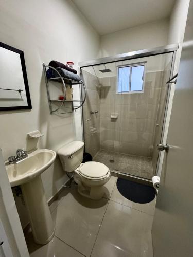a bathroom with a shower and a toilet and a sink at Casa en Privada! in Culiacán