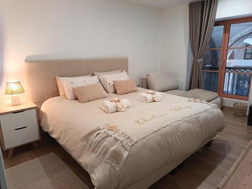 a bedroom with a large bed with towels on it at Centre Chambéry - Parking gratuit - tout inclus in Chambéry
