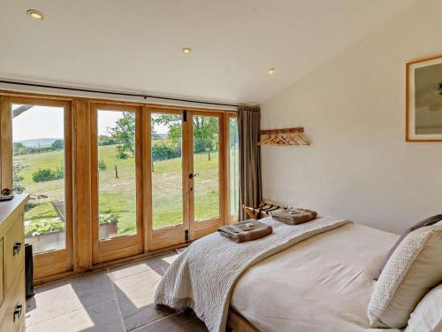 a bedroom with a bed and a large window at 2 Bed in Abergavenny oc-66630 in Dorstone
