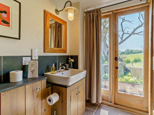 a bathroom with a sink and a sliding glass door at 2 Bed in Abergavenny oc-66630 in Dorstone