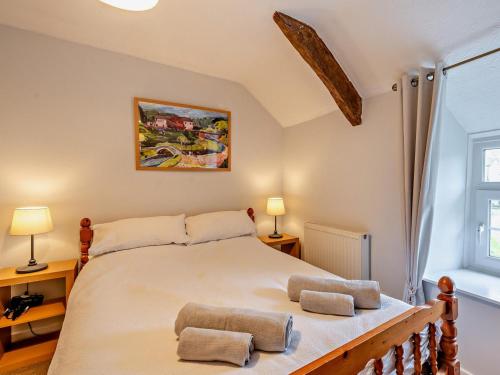 a bedroom with a large bed with two pillows on it at 2 Bed in Crickhowell oc-bn052 in Llangynidr