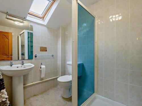a bathroom with a toilet and a sink and a shower at 3 Bed in Builth Wells oc-52463 in Alltmawr