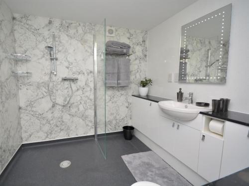 a bathroom with a glass shower and a sink at 1 Bed in Bideford oc-74817 in Bideford