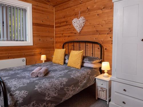 a bedroom with a bed in a wooden cabin at 3 Bed in Hereford oc-bn141 in Clyro