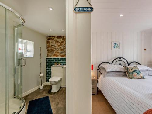 a bedroom with a bed and a bathroom with a shower at 1 Bed in Brixham oc-bx036 in Brixham