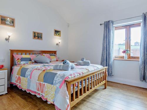 a bedroom with a large bed and a window at 2 Bed in Wellington oc-00467 in West Buckland