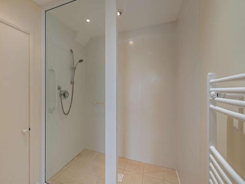 a bathroom with a shower with a glass door at 3 Bed in Bideford oc-bybur in Bideford