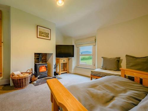 a bedroom with a bed and a fireplace and a tv at 2 Bed in Egremont oc-87227 in Egremont