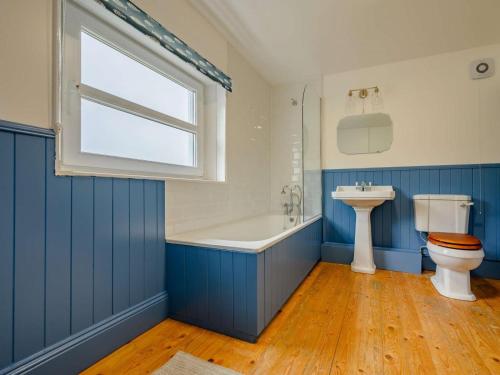 a bathroom with a tub and a toilet and a sink at 2 Bed in Egremont oc-87227 in Egremont