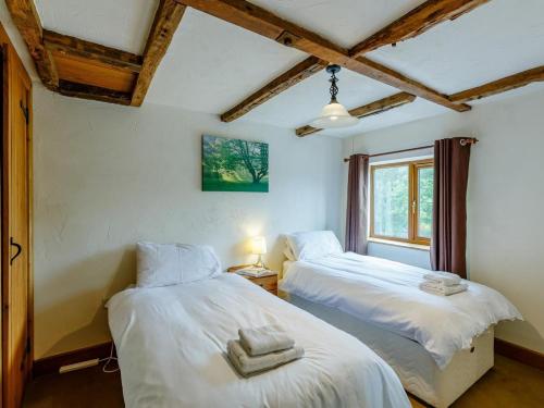 two beds in a room with a window at 3 Bed in Bridgnorth oc-therr in Shrewsbury