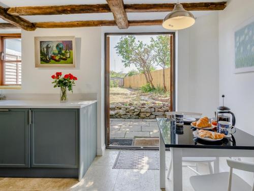 a kitchen with a table and a door to a yard at 3 Bed in Stratford-upon-avon oc-95736 in Stratford-upon-Avon