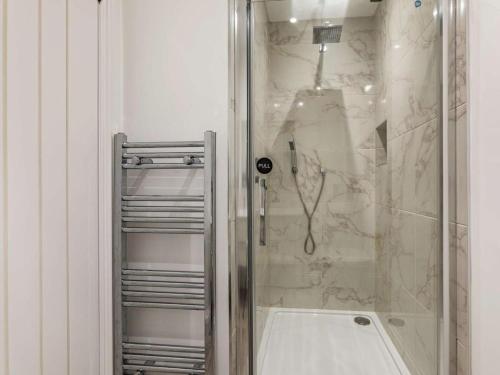 a shower with a glass door in a bathroom at 4 Bed in Bideford oc-86776 in Appledore