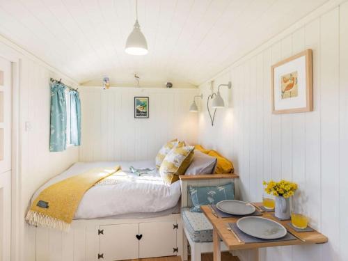 a small bedroom with a bed and a table at 1 Bed in Stockport oc-87592 in Mellor