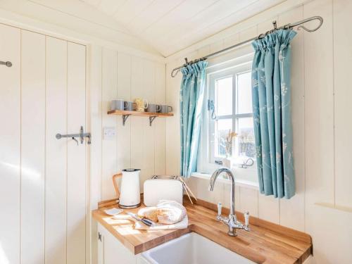 a kitchen with a sink and a window at 1 Bed in Stockport oc-87592 in Mellor