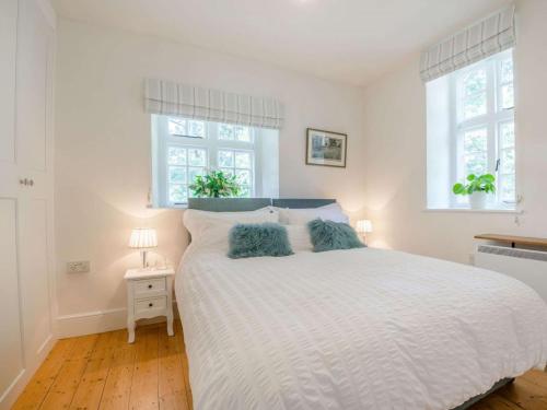a bedroom with a large white bed with two pillows at 1 Bed in Brecon oc-88748 in Aber-Brân