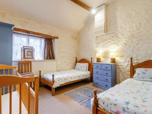 a bedroom with two beds and a blue dresser at 3 Bed in Abergavenny oc-90233 in Llanvetherine