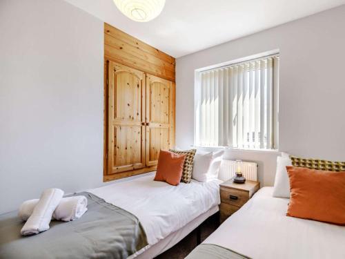 a bedroom with two beds and a window at 5 Bed in Matlock oc-88486 in Crich
