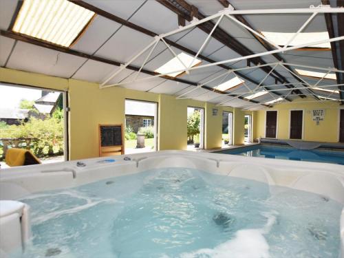 a hot tub in a room with a swimming pool at 2 Bed in Abergavenny oc-90235 in Llanvetherine