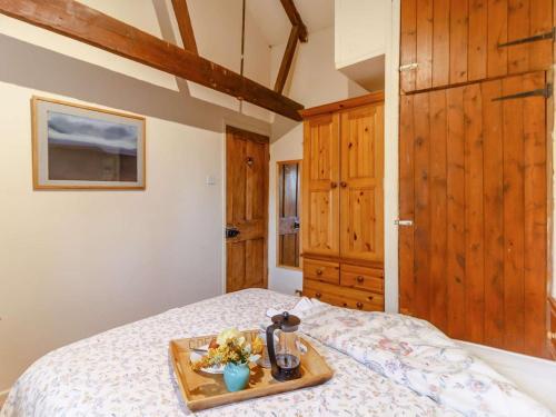 a tray of food on a bed in a bedroom at 2 Bed in Abergavenny oc-90235 in Llanvetherine