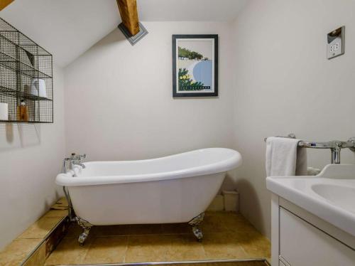 a white bath tub in a bathroom with a sink at 2 Bed in Bakewell oc-91038 in Bakewell