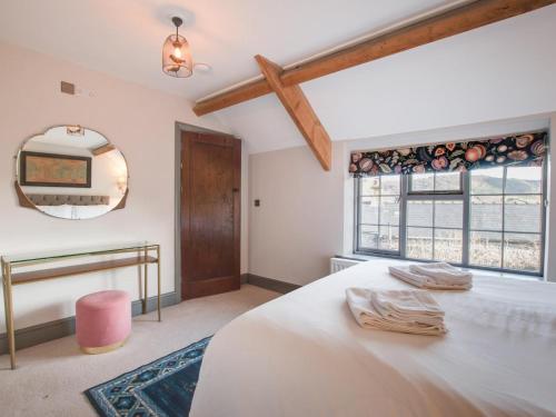 a bedroom with a large white bed and a mirror at 2 Bed in Bakewell oc-91038 in Bakewell
