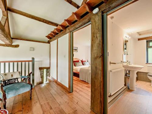 a room with a bedroom and a bed and a mirror at 3 Bed in Llandovery oc-bn093 in Llandovery