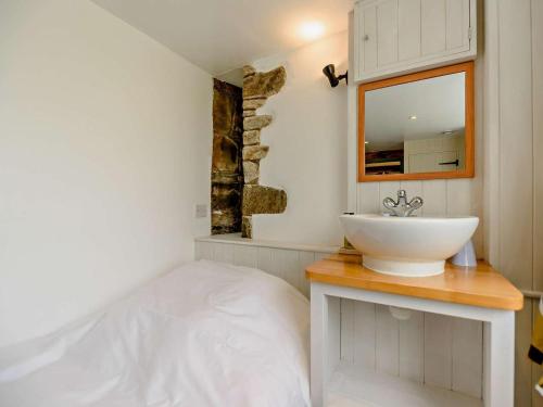 a bathroom with a white sink and a mirror at 3 Bed in Llandovery oc-bn093 in Llandovery