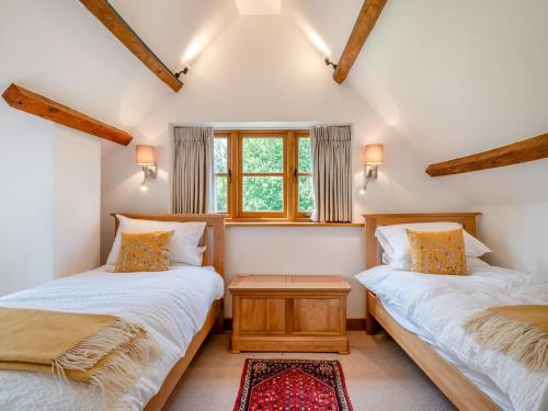 a bedroom with two beds and a window at 2 Bed in Chepstow oc-95046 in Chepstow