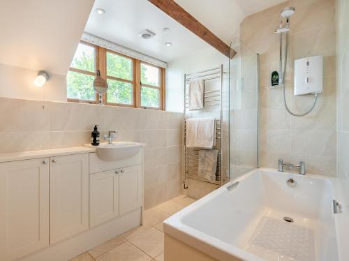 a bathroom with a tub and a sink and a shower at 2 Bed in Chepstow oc-95046 in Chepstow