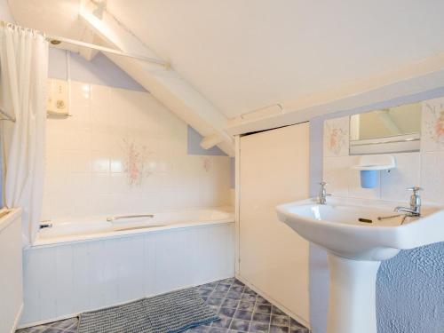 a bathroom with a sink and a bath tub at 5 Bed in Brecon oc-90660 in Lower Chapel