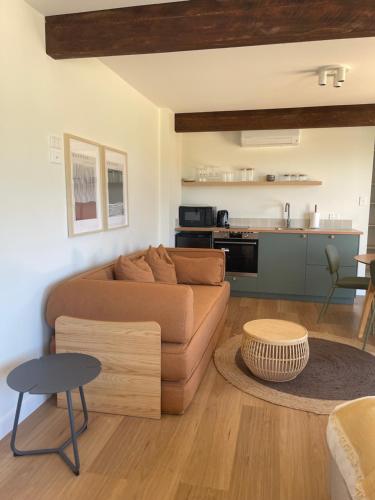 a living room with a couch and a table at Archy's on the Lake in Burrill Lake