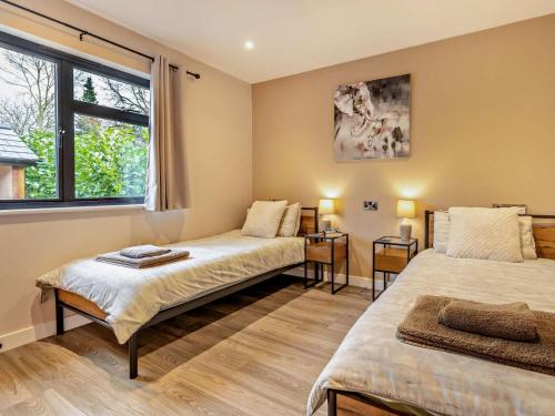 a room with two beds and a window at 2 Bed in Knighton oc-94202 in Knighton