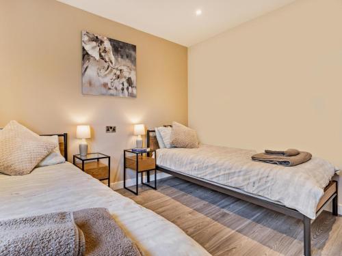 two beds in a room with two lamps at 2 Bed in Knighton oc-94203 in Knighton