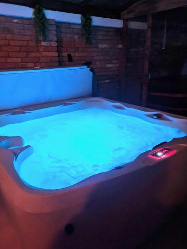 a jacuzzi tub in a building at night at Végvári Vendégház in Magyarbóly