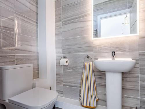 a bathroom with a white toilet and a sink at 1 Bed in Barnstaple oc-77349 in Loxhore