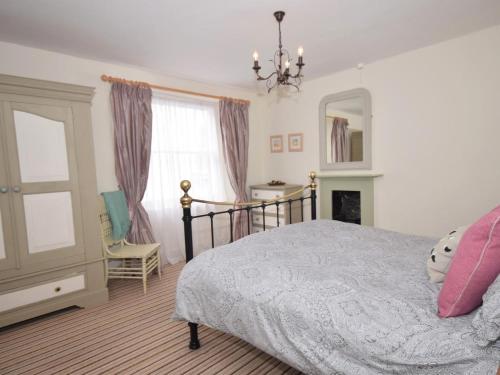 a bedroom with a bed and a mirror and a chair at 2 Bed in Bideford oc-tcdolph in Appledore