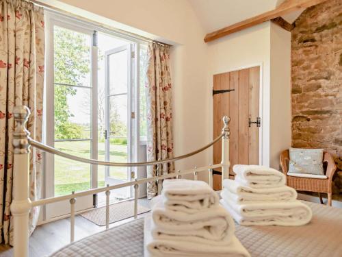 a room with a bed with towels on it at 1 Bed in Craven Arms oc-54928 in Clungunford